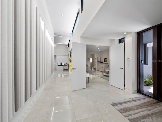 corridor with marble finish floor