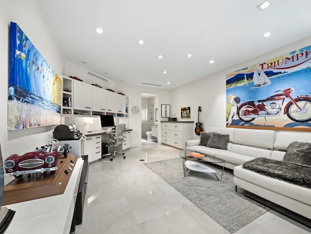 living area with built in desk and recessed lighting