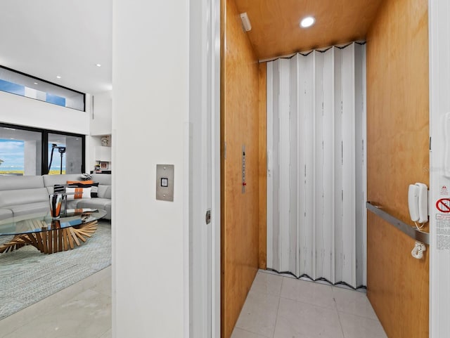 hall with tile patterned flooring and recessed lighting