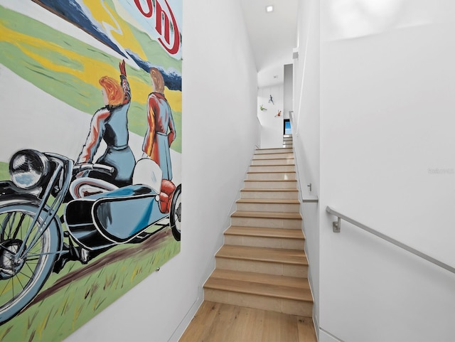 stairway featuring baseboards and wood finished floors