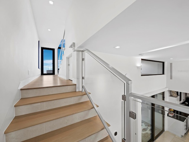 stairs featuring recessed lighting