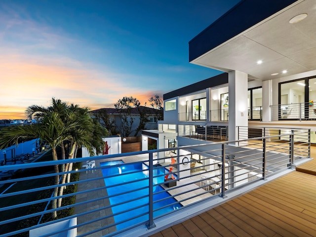 view of pool at dusk