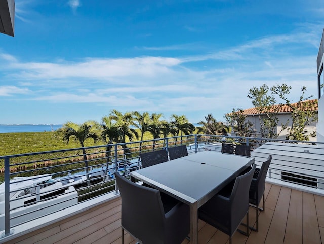 wooden terrace featuring a water view