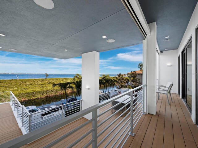 wooden deck featuring a water view