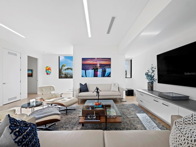 living room with wood finished floors and visible vents