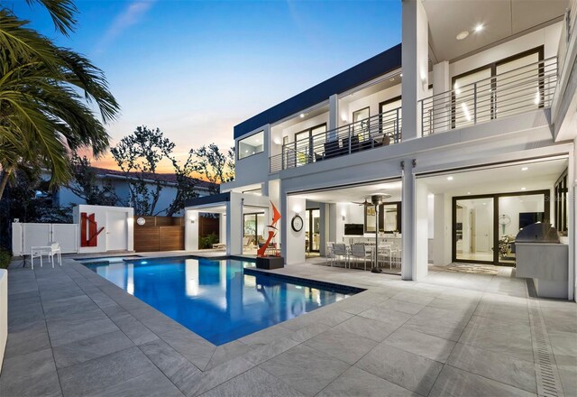 view of pool with a fenced in pool, a patio area, fence, and an outdoor kitchen