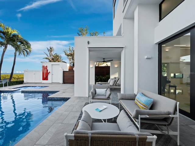 pool with an in ground hot tub, a patio area, and an outdoor living space