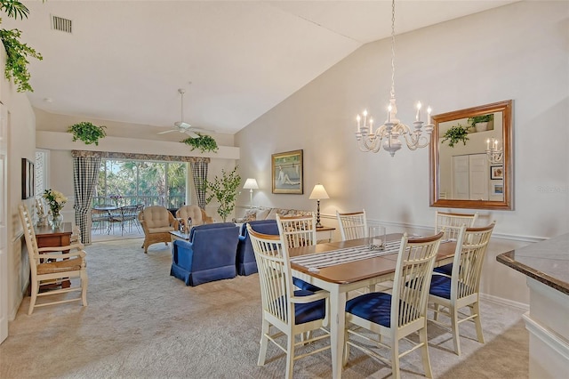 dining room featuring high vaulted ceiling, ceiling fan with notable chandelier, visible vents, and light colored carpet