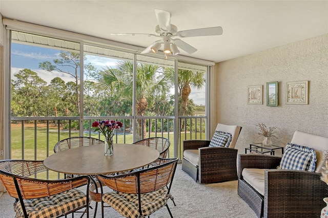 sunroom featuring ceiling fan