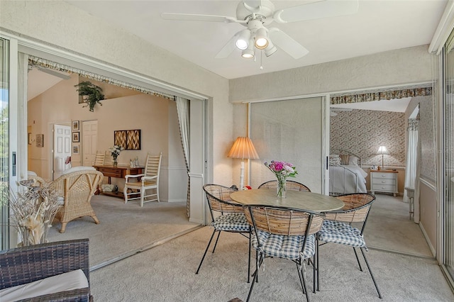 dining room featuring light carpet and a ceiling fan