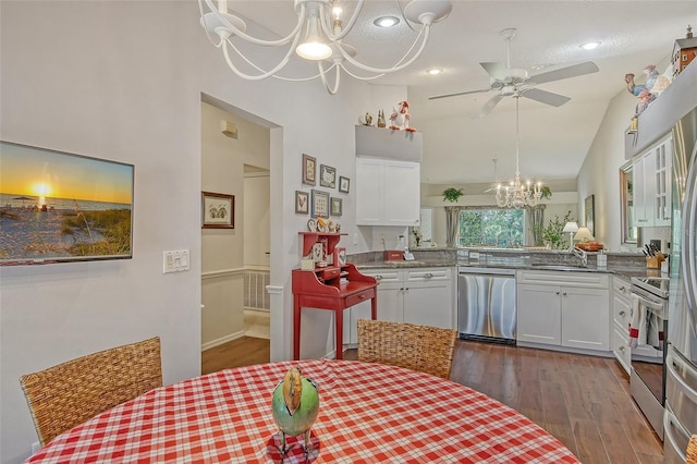 kitchen featuring stainless steel appliances, ceiling fan with notable chandelier, white cabinetry, and dark wood-style floors