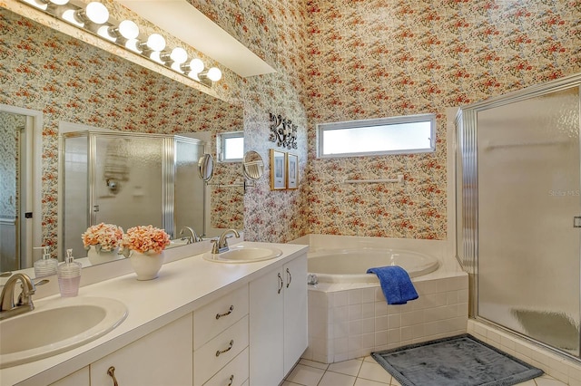 bathroom with wallpapered walls, a shower stall, and a sink