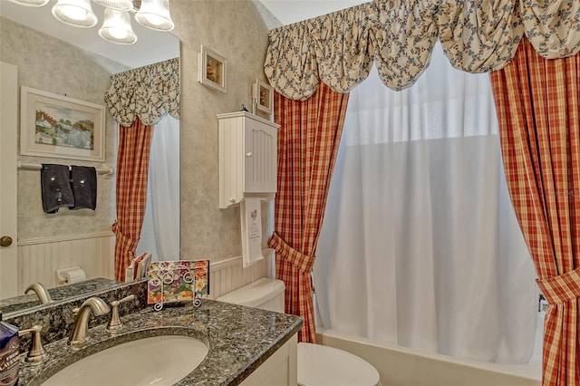 full bathroom with shower / bathtub combination with curtain, toilet, and vanity