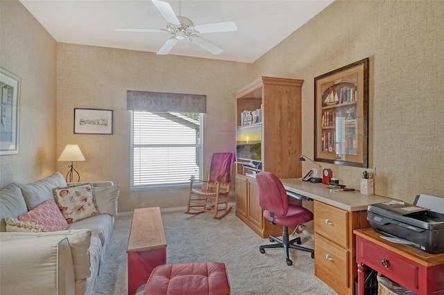 office featuring light carpet, a ceiling fan, and baseboards