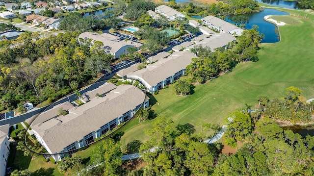 aerial view featuring a water view, view of golf course, and a residential view