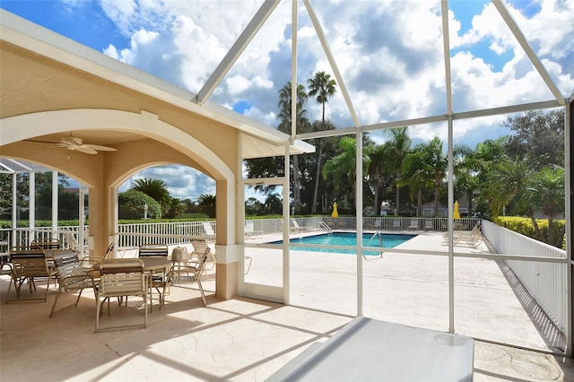 community pool featuring ceiling fan, a lanai, a patio, and fence