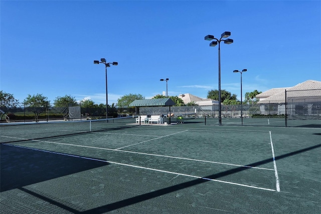 view of tennis court with fence