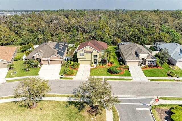 birds eye view of property with a residential view and a forest view