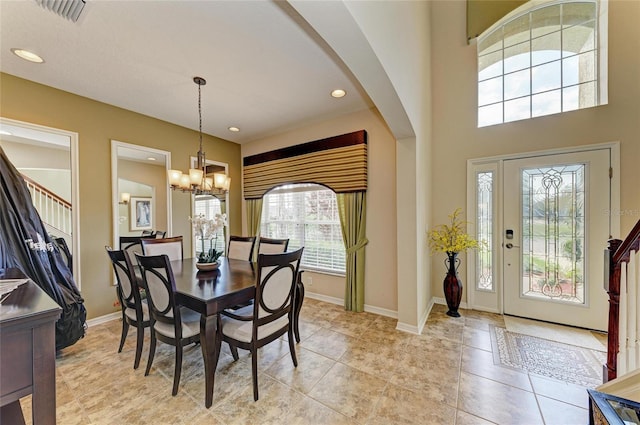 dining room featuring baseboards, light tile patterned flooring, visible vents, and an inviting chandelier