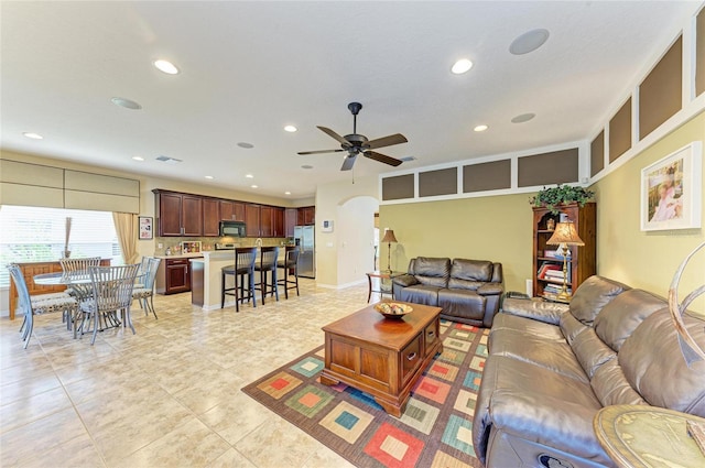 living area with light tile patterned floors, a ceiling fan, and recessed lighting