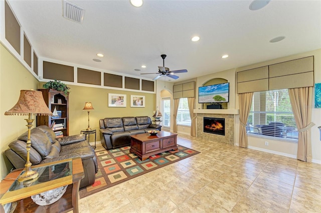 living area with baseboards, visible vents, a wealth of natural light, and recessed lighting