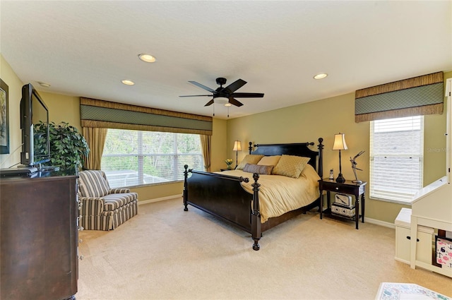 bedroom with recessed lighting, light colored carpet, baseboards, and multiple windows