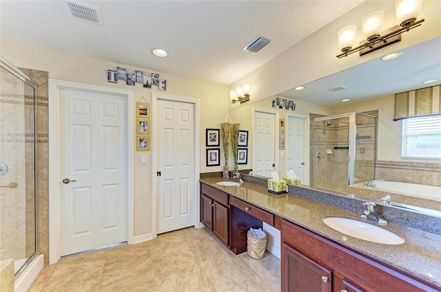 full bath with a stall shower, visible vents, and a sink