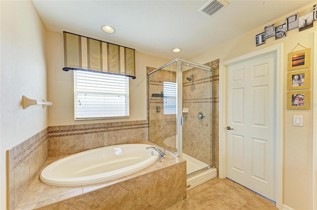 bathroom with a garden tub, tile patterned floors, visible vents, and a stall shower