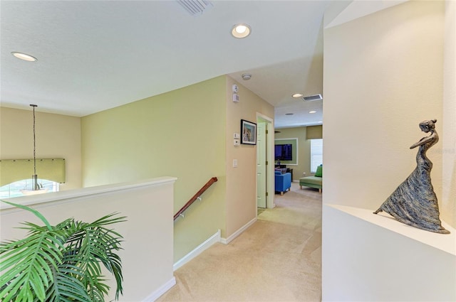 hallway with baseboards, visible vents, carpet flooring, an upstairs landing, and recessed lighting