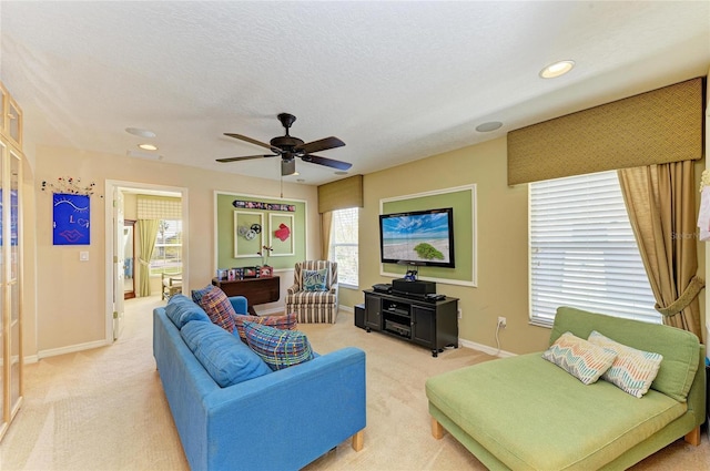 living room with light carpet, baseboards, a textured ceiling, and recessed lighting