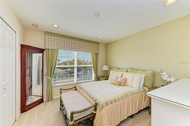 bedroom with baseboards, recessed lighting, and light colored carpet