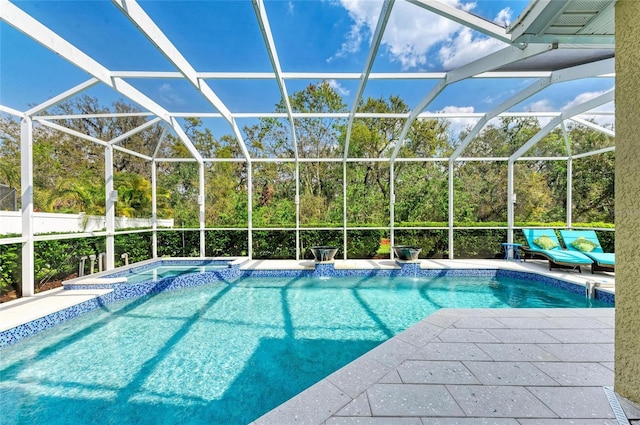 view of pool with a patio, a lanai, and a pool with connected hot tub