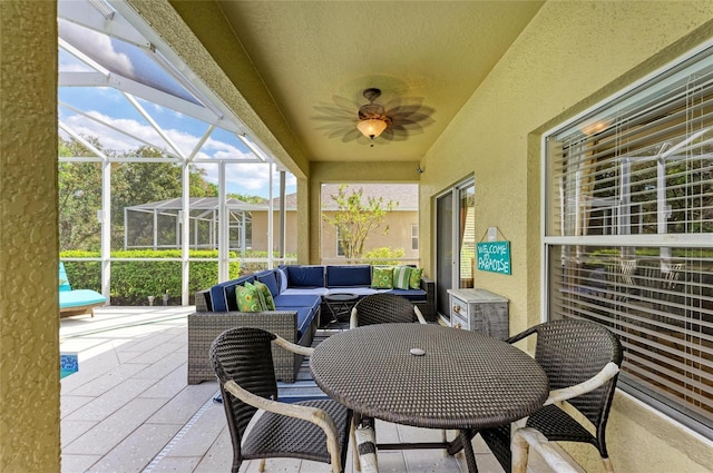 sunroom featuring ceiling fan