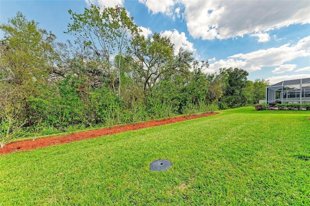 view of yard with glass enclosure