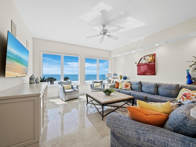 living area featuring visible vents, baseboards, and ceiling fan