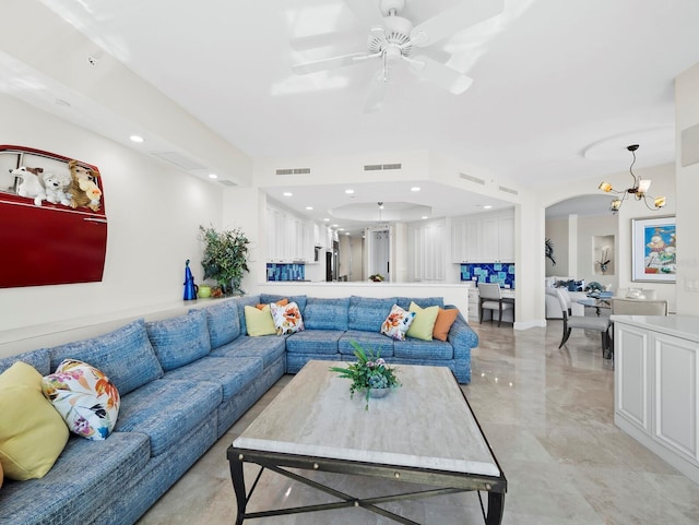 living room featuring recessed lighting, visible vents, and arched walkways