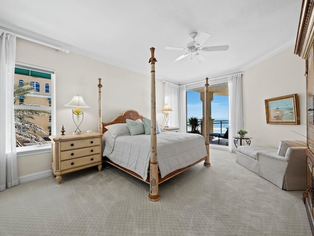 carpeted bedroom with access to outside, a ceiling fan, baseboards, and ornamental molding