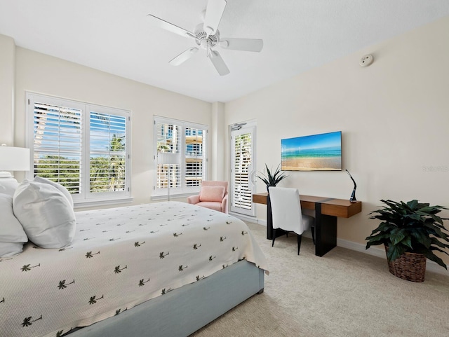 carpeted bedroom featuring baseboards and ceiling fan