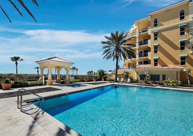 pool featuring a gazebo and a patio area