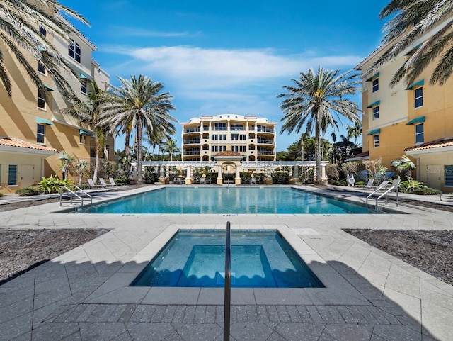 view of pool with a community hot tub and a patio