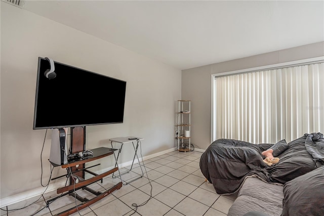 living room featuring baseboards and light tile patterned floors