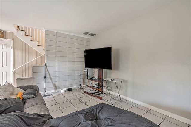 tiled living room with visible vents and baseboards