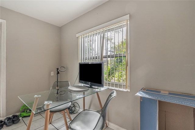 office area with baseboards and tile patterned floors