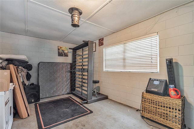 miscellaneous room featuring concrete flooring and concrete block wall