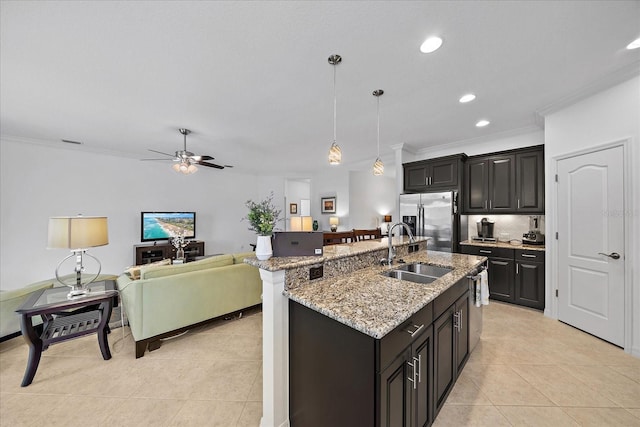 kitchen with light tile patterned floors, decorative backsplash, appliances with stainless steel finishes, ornamental molding, and a sink