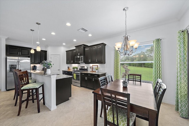 kitchen featuring a chandelier, stainless steel appliances, visible vents, light stone countertops, and decorative light fixtures