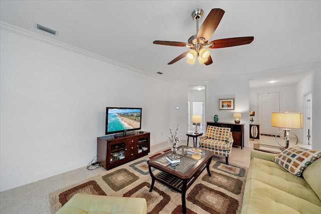 tiled living area featuring ceiling fan, visible vents, and crown molding