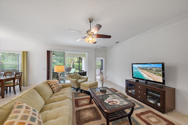 living area with plenty of natural light, visible vents, ornamental molding, and a ceiling fan