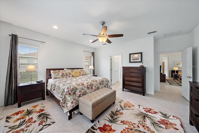 bedroom with ceiling fan, multiple windows, light tile patterned flooring, and visible vents