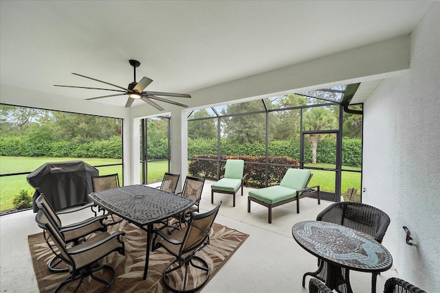 sunroom featuring a ceiling fan